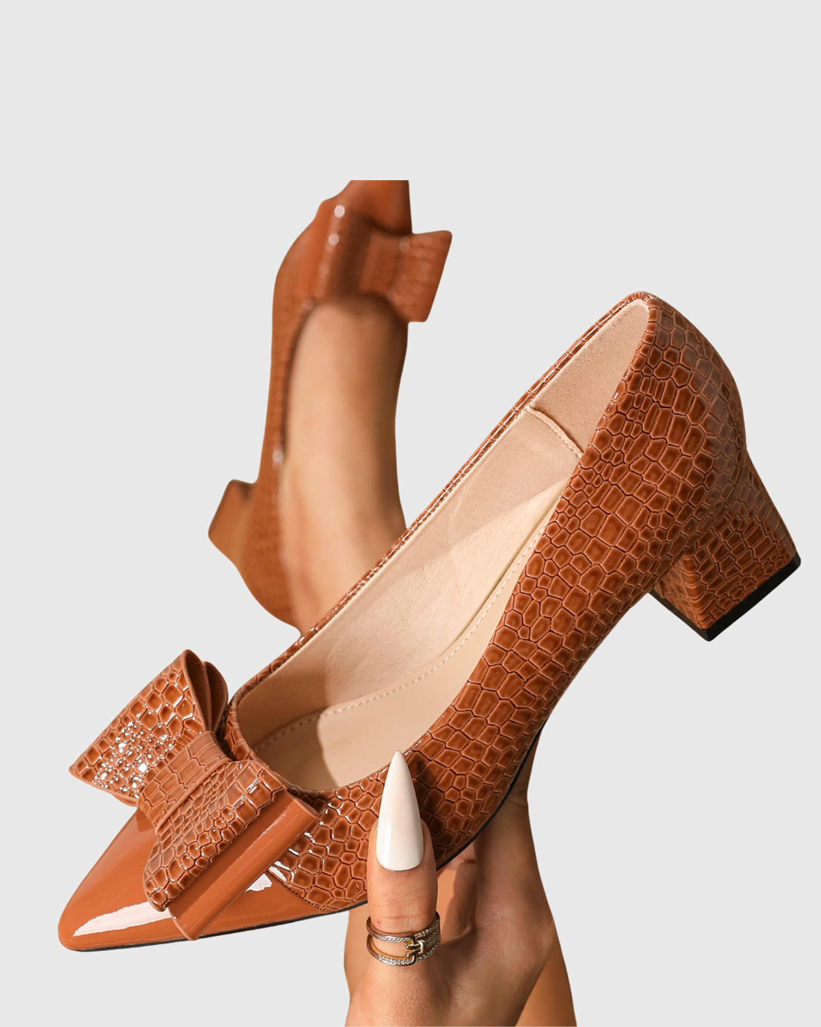 Zevala Bow Crocodile Print Pumps In Brown